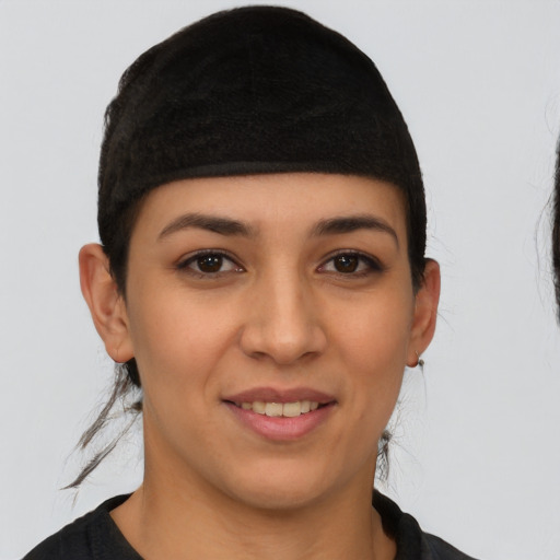 Joyful latino young-adult female with short  brown hair and brown eyes