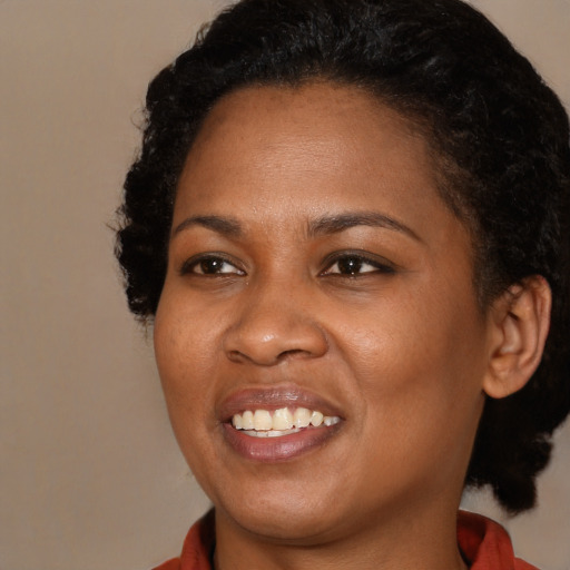 Joyful black young-adult female with medium  black hair and brown eyes