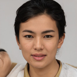 Joyful asian young-adult female with medium  brown hair and brown eyes