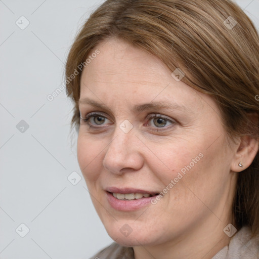 Joyful white adult female with medium  brown hair and blue eyes