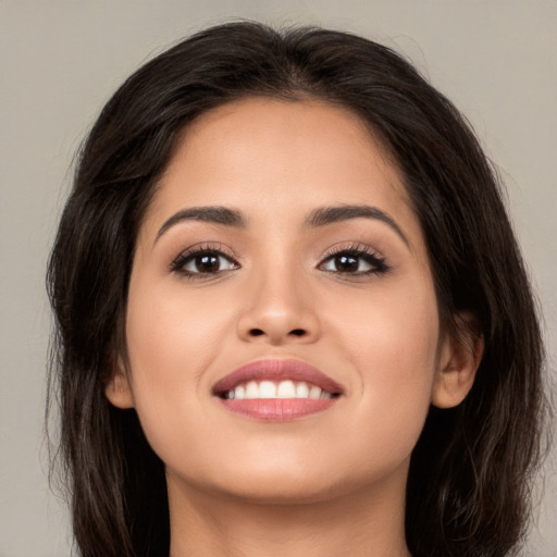 Joyful white young-adult female with long  brown hair and brown eyes