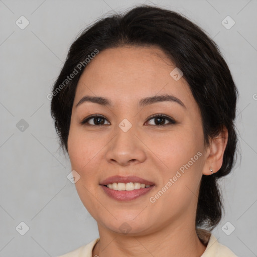 Joyful latino young-adult female with medium  brown hair and brown eyes