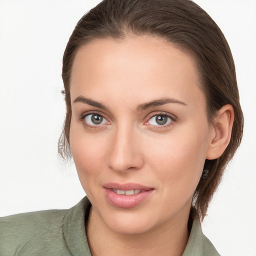 Joyful white young-adult female with medium  brown hair and grey eyes