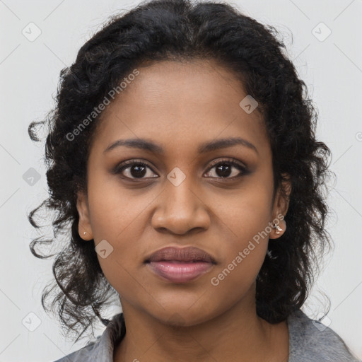 Joyful black young-adult female with long  brown hair and brown eyes