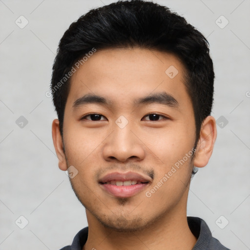 Joyful asian young-adult male with short  black hair and brown eyes