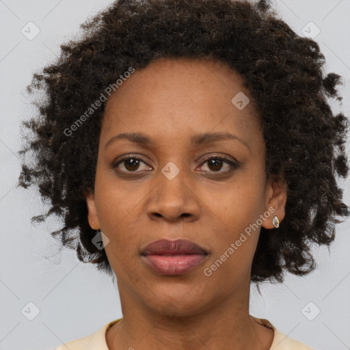 Joyful black adult female with short  brown hair and brown eyes