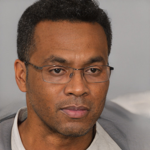 Neutral black adult male with short  brown hair and brown eyes