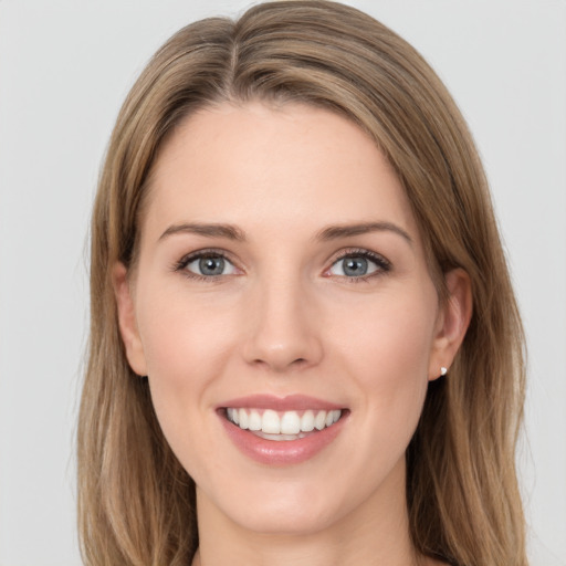 Joyful white young-adult female with long  brown hair and grey eyes