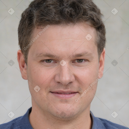 Joyful white adult male with short  brown hair and grey eyes