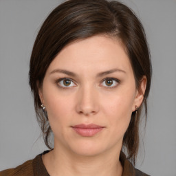 Joyful white young-adult female with medium  brown hair and brown eyes