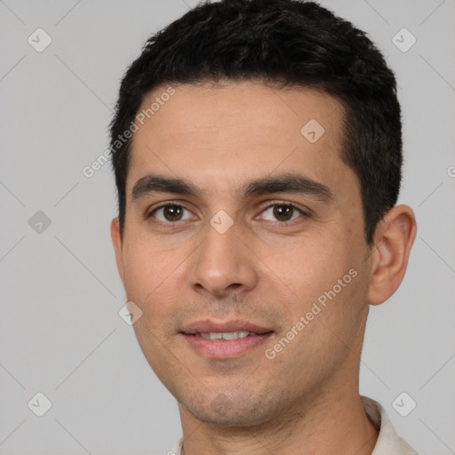 Joyful white young-adult male with short  black hair and brown eyes