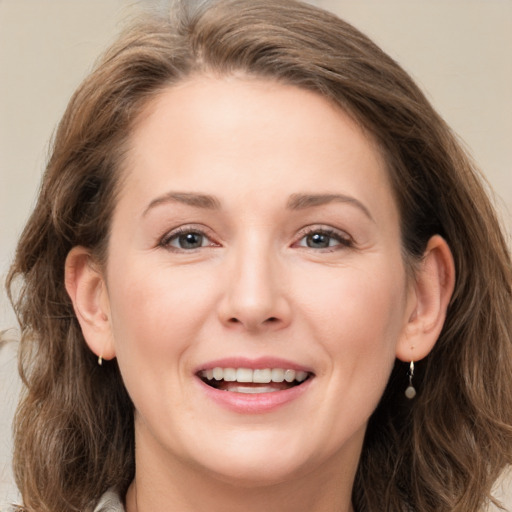 Joyful white young-adult female with long  brown hair and grey eyes