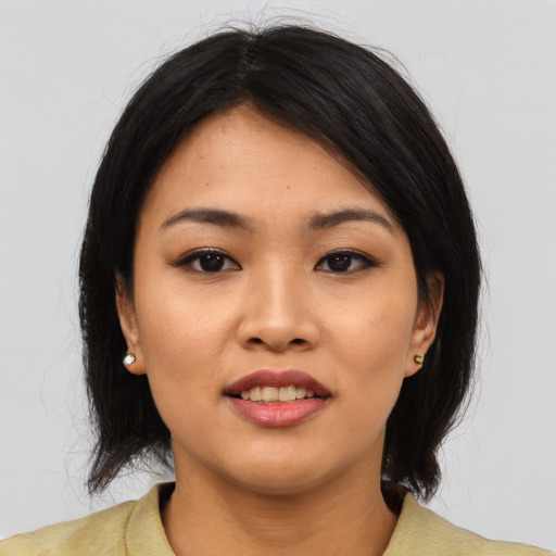 Joyful asian young-adult female with medium  black hair and brown eyes