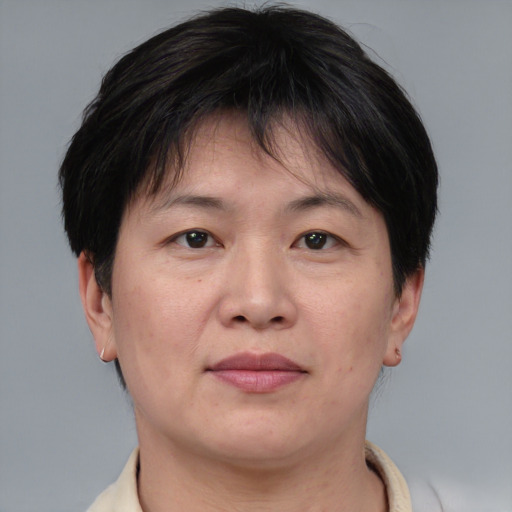 Joyful asian adult female with short  brown hair and brown eyes