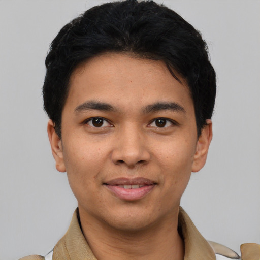 Joyful latino young-adult male with short  black hair and brown eyes