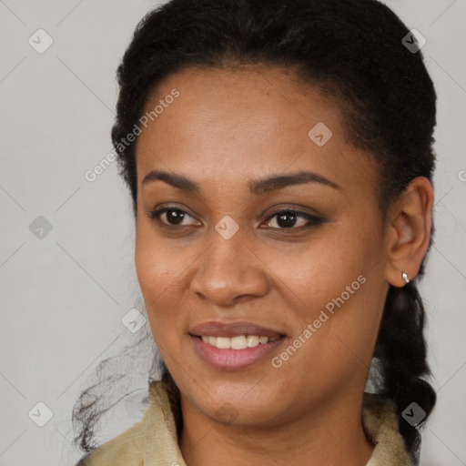 Joyful black young-adult female with long  brown hair and brown eyes