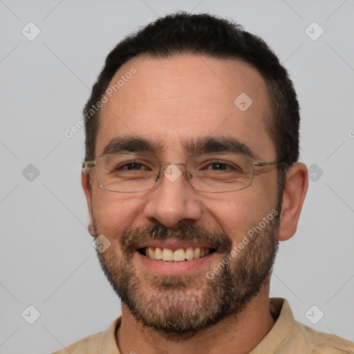 Joyful white adult male with short  black hair and brown eyes