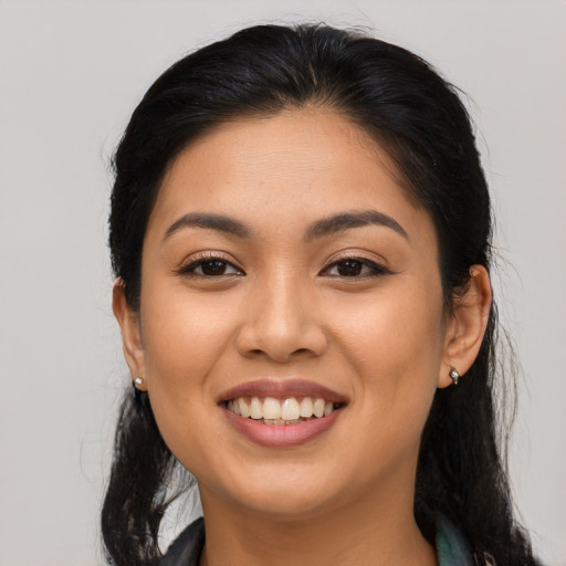 Joyful asian young-adult female with long  brown hair and brown eyes