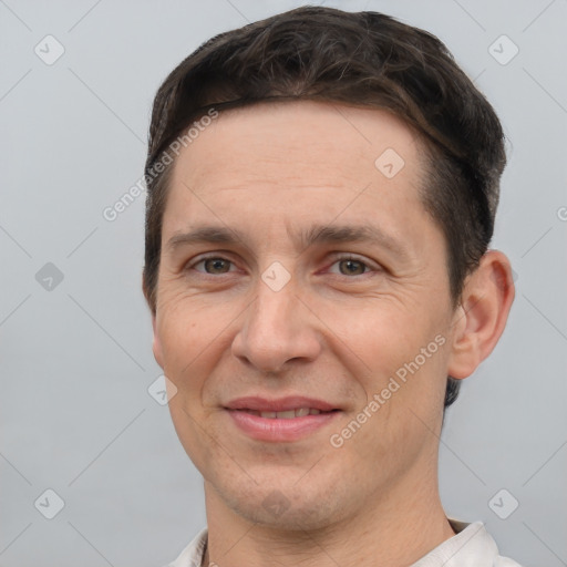 Joyful white adult male with short  brown hair and brown eyes