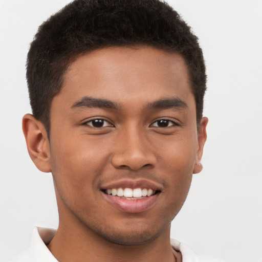 Joyful latino young-adult male with short  brown hair and brown eyes