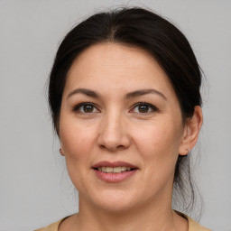 Joyful white adult female with medium  brown hair and brown eyes