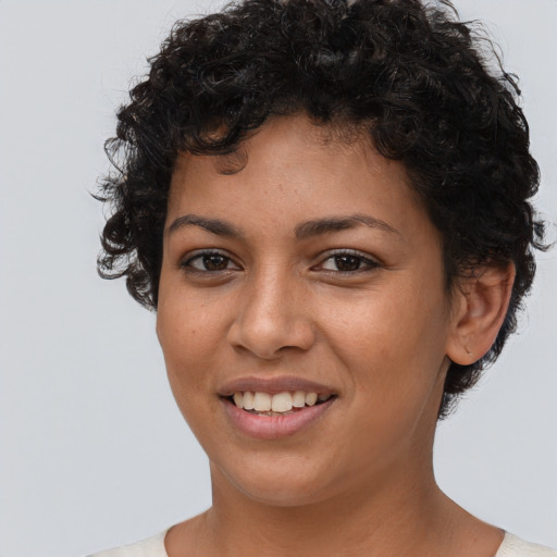 Joyful latino young-adult female with short  brown hair and brown eyes