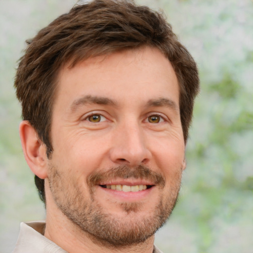 Joyful white adult male with short  brown hair and brown eyes