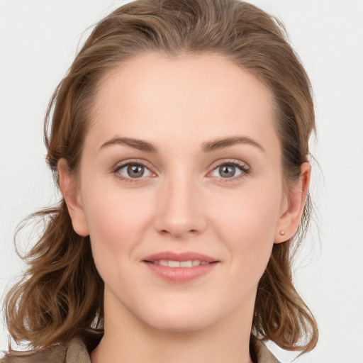 Joyful white young-adult female with long  brown hair and grey eyes