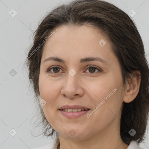 Joyful white adult female with medium  brown hair and brown eyes