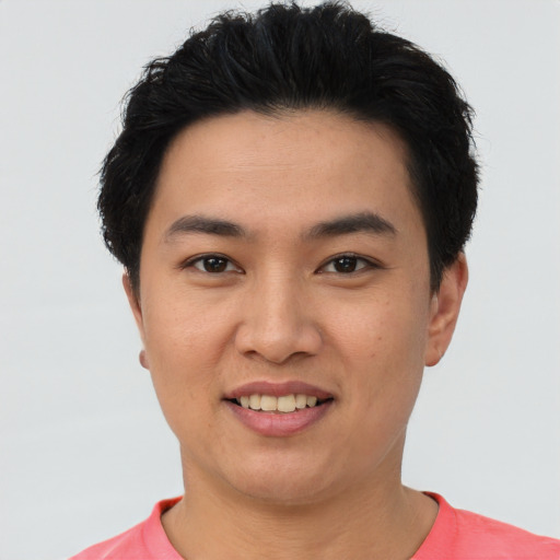 Joyful asian young-adult male with short  black hair and brown eyes