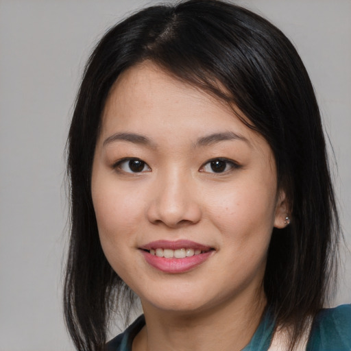 Joyful asian young-adult female with medium  brown hair and brown eyes