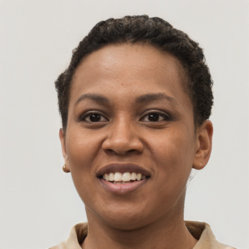 Joyful black young-adult female with short  brown hair and brown eyes