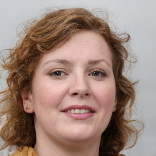 Joyful white young-adult female with medium  brown hair and blue eyes