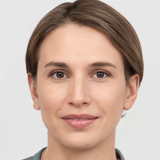 Joyful white young-adult female with short  brown hair and grey eyes