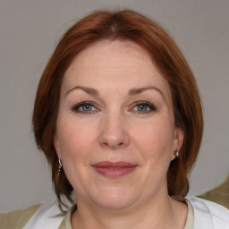 Joyful white adult female with medium  brown hair and blue eyes