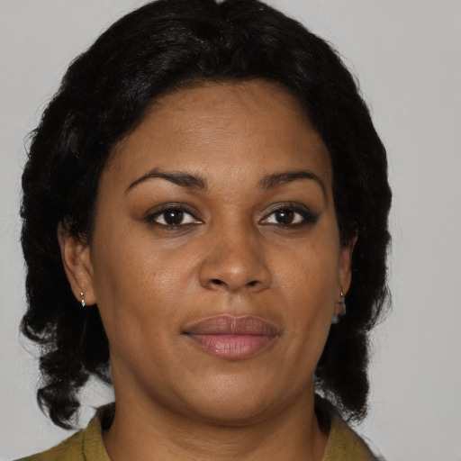 Joyful black adult female with medium  brown hair and brown eyes