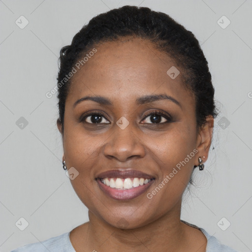 Joyful black young-adult female with short  black hair and brown eyes