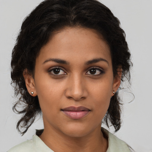 Joyful latino young-adult female with medium  brown hair and brown eyes