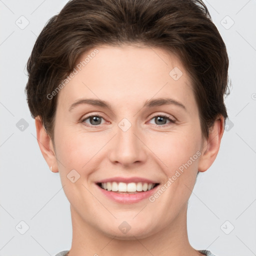 Joyful white young-adult female with short  brown hair and grey eyes