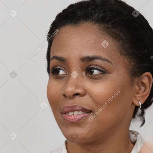 Joyful black young-adult female with short  black hair and brown eyes