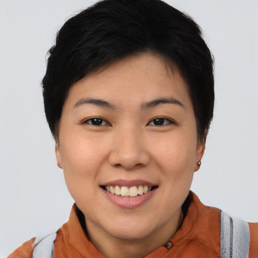 Joyful asian young-adult female with short  black hair and brown eyes