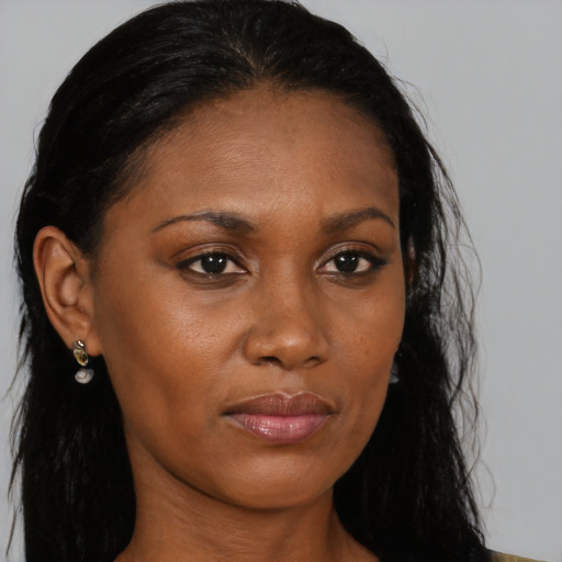 Joyful black young-adult female with long  brown hair and brown eyes