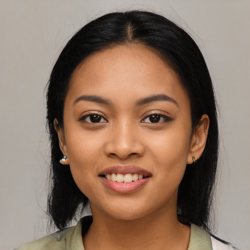 Joyful asian young-adult female with long  black hair and brown eyes