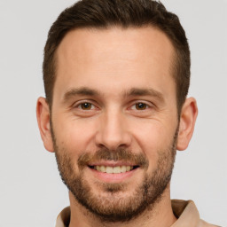 Joyful white adult male with short  brown hair and brown eyes