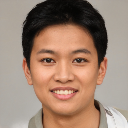Joyful asian young-adult male with short  brown hair and brown eyes