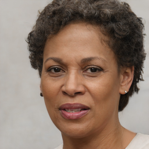 Joyful black adult female with short  brown hair and brown eyes