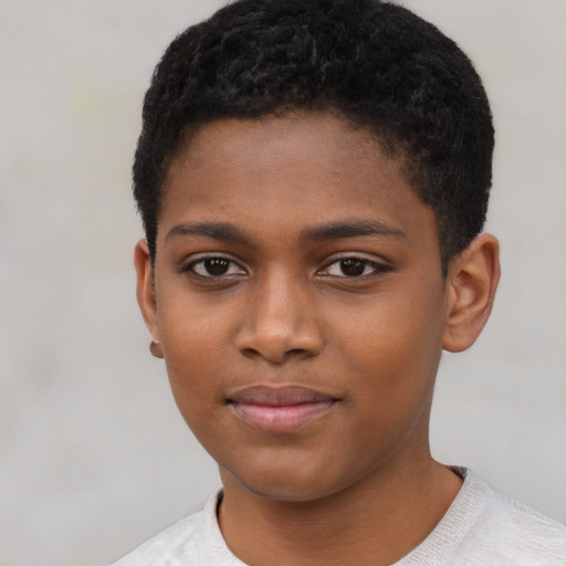 Joyful black child male with short  black hair and brown eyes