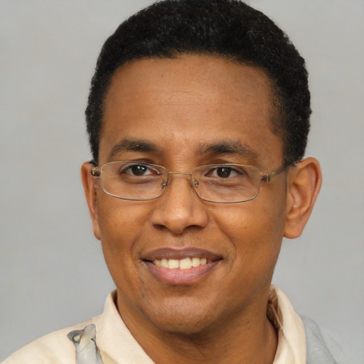 Joyful latino adult male with short  brown hair and brown eyes