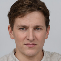 Joyful white adult male with short  brown hair and grey eyes