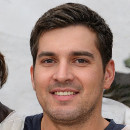 Joyful white young-adult male with short  brown hair and brown eyes